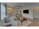 Open living room with hardwood floors, plush sectional, and modern recessed lighting, perfect for relaxation at 5638 Maple Bluff Way, Hoschton, GA 30548