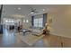 Spacious living room with hardwood floors, a comfortable sectional, and open access to the modern kitchen at 5638 Maple Bluff Way, Hoschton, GA 30548