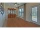 Neutral living room boasts hardwood floors, natural light, and elegant built-in shelving at 5638 Maple Bluff Way, Hoschton, GA 30548