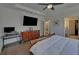 Bedroom with a study desk, TV and hardwood floors offering a refined and comfortable space at 5638 Maple Bluff Way, Hoschton, GA 30548