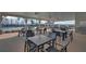 Outdoor dining area featuring tables, chairs, and ceiling fans at 5638 Maple Bluff Way, Hoschton, GA 30548
