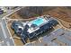 Aerial view of a community pool with lounge areas and a clubhouse at 5638 Maple Bluff Way, Hoschton, GA 30548