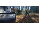 A serene backyard with a deck and shady trees providing a private outdoor retreat at 1 Hidden Valley Dr, Lawrenceville, GA 30044