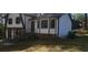 A charming house featuring light siding, stone accents, a dark roof, and a well-maintained front yard at 1 Hidden Valley Dr, Lawrenceville, GA 30044