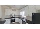 Bright kitchen featuring white cabinets, black countertops, and stainless steel appliances at 1 Hidden Valley Dr, Lawrenceville, GA 30044