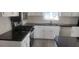 Modern kitchen featuring white cabinets, dark countertops, and stainless steel appliances at 1 Hidden Valley Dr, Lawrenceville, GA 30044