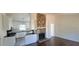 Cozy living room and kitchen with a stone fireplace, white cabinets, and stainless steel appliances at 1 Hidden Valley Dr, Lawrenceville, GA 30044