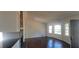 Bright living room featuring hardwood floors, a bay window, and stone fireplace at 1 Hidden Valley Dr, Lawrenceville, GA 30044