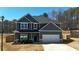 Charming two-story home with neutral siding, a two car garage, and a landscaped front yard at 261 Webster Lake Dr, Temple, GA 30179