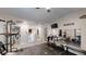 A home gym featuring exercise equipment, a mounted TV, and mirrors for training at 261 Webster Lake Dr, Temple, GA 30179