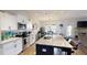 Well-lit kitchen features granite countertops, stainless steel appliances, and a central island with seating at 261 Webster Lake Dr, Temple, GA 30179