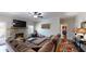 Spacious living room with a stone fireplace, large sectional, and modern decor creating a cozy atmosphere at 261 Webster Lake Dr, Temple, GA 30179