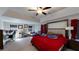 A primary bedroom with a red bedspread, large windows, and a home office area at 261 Webster Lake Dr, Temple, GA 30179