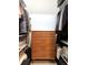 Walk-in closet features ample storage space and a central wooden dresser at 2630 Talley St # 426, Decatur, GA 30030