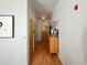 Hallway with light walls, hardwood floors, and wooden doors, accented by artwork and decor at 2630 Talley St # 426, Decatur, GA 30030