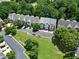 Community aerial view showcases lush greenery, well-maintained townhomes, and convenient parking at 1020 Constitution Way, Cumming, GA 30040