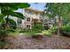 Expansive backyard with lush landscaping, mature trees, deck, and patio for outdoor enjoyment at 1020 Constitution Way, Cumming, GA 30040