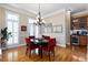 Open dining room featuring hardwood floors, a stylish chandelier, and a built-in beverage center at 1020 Constitution Way, Cumming, GA 30040