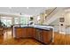 Large kitchen with a breakfast bar, stainless steel appliances, and a view into the spacious living area at 1020 Constitution Way, Cumming, GA 30040