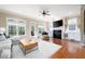 Cozy living room with ample windows, a fireplace, and hardwood floors, creating a perfect relaxation space at 1020 Constitution Way, Cumming, GA 30040