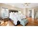 Bright main bedroom with hardwood floors, and a cozy ottoman at 1020 Constitution Way, Cumming, GA 30040