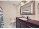 Bathroom with a white tiled floor, dark wood vanity, and tub with shower at 1496 Leafmore Pl, Decatur, GA 30033