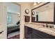 Bathroom featuring a granite countertop, dark wood cabinetry, and a view into an adjacent bedroom at 1496 Leafmore Pl, Decatur, GA 30033