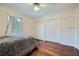 Bedroom showcasing hardwood floors, closet space, and modern ceiling fan at 1496 Leafmore Pl, Decatur, GA 30033