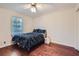 Cozy bedroom features a ceiling fan, wood floors and a bright window at 1496 Leafmore Pl, Decatur, GA 30033