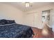 Bedroom features a double bed, closet, and hardwood floors at 1496 Leafmore Pl, Decatur, GA 30033