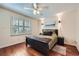 Cozy bedroom with hardwood floors, a ceiling fan, and natural light from shuttered windows at 1496 Leafmore Pl, Decatur, GA 30033