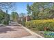 Community entrance with brick path, gate, bushes and spring flowers at 1496 Leafmore Pl, Decatur, GA 30033