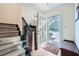 Entryway with staircase and dark wood floors with an open door and view to the outside at 1496 Leafmore Pl, Decatur, GA 30033