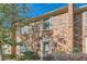 Detailed view of brick townhome's facade featuring classic shutters and a well-maintained exterior at 1496 Leafmore Pl, Decatur, GA 30033