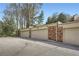 View of garages along a parking lot, adjacent to brick apartment buildings at 1496 Leafmore Pl, Decatur, GA 30033