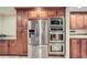 Modern kitchen with stainless steel appliances, custom cabinets, and stone flooring at 1496 Leafmore Pl, Decatur, GA 30033