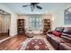 Inviting living room featuring hardwood floors, built-in bookshelves, and a comfortable leather sofa at 1496 Leafmore Pl, Decatur, GA 30033