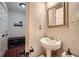 Charming powder room boasts a pedestal sink, decorative mirror, and vintage-style fixtures at 1496 Leafmore Pl, Decatur, GA 30033