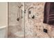 Shower features decorative mosaic tile, a glass enclosure and built-in shelf at 1496 Leafmore Pl, Decatur, GA 30033