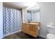 Full bathroom features a vanity, sleek mirror, modern light fixture, and patterned shower curtain at 170 Boulevard Se # 421 H, Atlanta, GA 30312