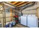 Well-lit laundry room with modern washer and dryer, shelving and paint cans on shelving unit at 170 Boulevard Se # 421 H, Atlanta, GA 30312