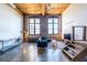 Open loft living area with tall ceilings, exposed brick, and large arched windows at 170 Boulevard Se # 421 H, Atlanta, GA 30312