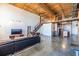Modern loft living room with hardwood floors, open staircase and exposed wood beam ceilings at 170 Boulevard Se # 421 H, Atlanta, GA 30312