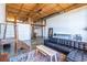 Living area featuring a loft, wooden ceilings, concrete floor, and a leather sectional at 170 Boulevard Se # 421 H, Atlanta, GA 30312