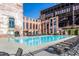 Community pool with clear blue water and comfortable lounge chairs in a brick building backdrop at 170 Boulevard Se # 421 H, Atlanta, GA 30312