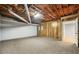 Spacious basement area with carpet flooring, wood paneling and an open doorway to another room at 2051 E Piedmont Rd, Marietta, GA 30062