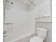 White bathtub and shower combination includes a shower caddy and a storage unit at 2051 E Piedmont Rd, Marietta, GA 30062