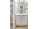 Bright bathroom vanity with white cabinets, gold fixtures, and decorative shelving at 2051 E Piedmont Rd, Marietta, GA 30062
