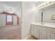 Bright bathroom features a white vanity and view into the carpeted bedroom at 2051 E Piedmont Rd, Marietta, GA 30062