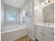 Bright bathroom showcasing soaking tub with window view and a vanity at 2051 E Piedmont Rd, Marietta, GA 30062